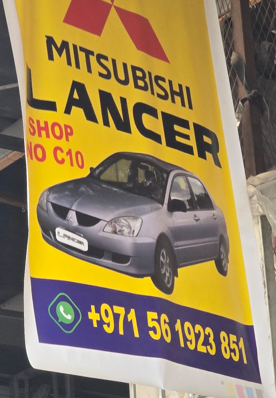 Banner photographed at Mitsubishi stall of DAR AL FARAH USED USED AUTO SPARE PARTS