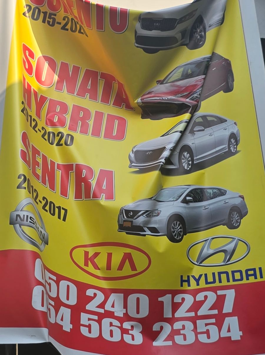 Banner photographed at Nissan, Kia, Hyundai stall of DAR AL FARAH USED USED AUTO SPARE PARTS