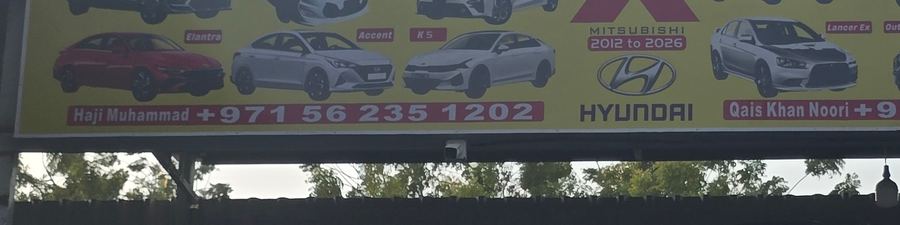Banner photographed at Kia, Hyundai, Mitsubishi stall of AL BAHAR AL MAFTOOH USED CARS & SPARE PARTS
