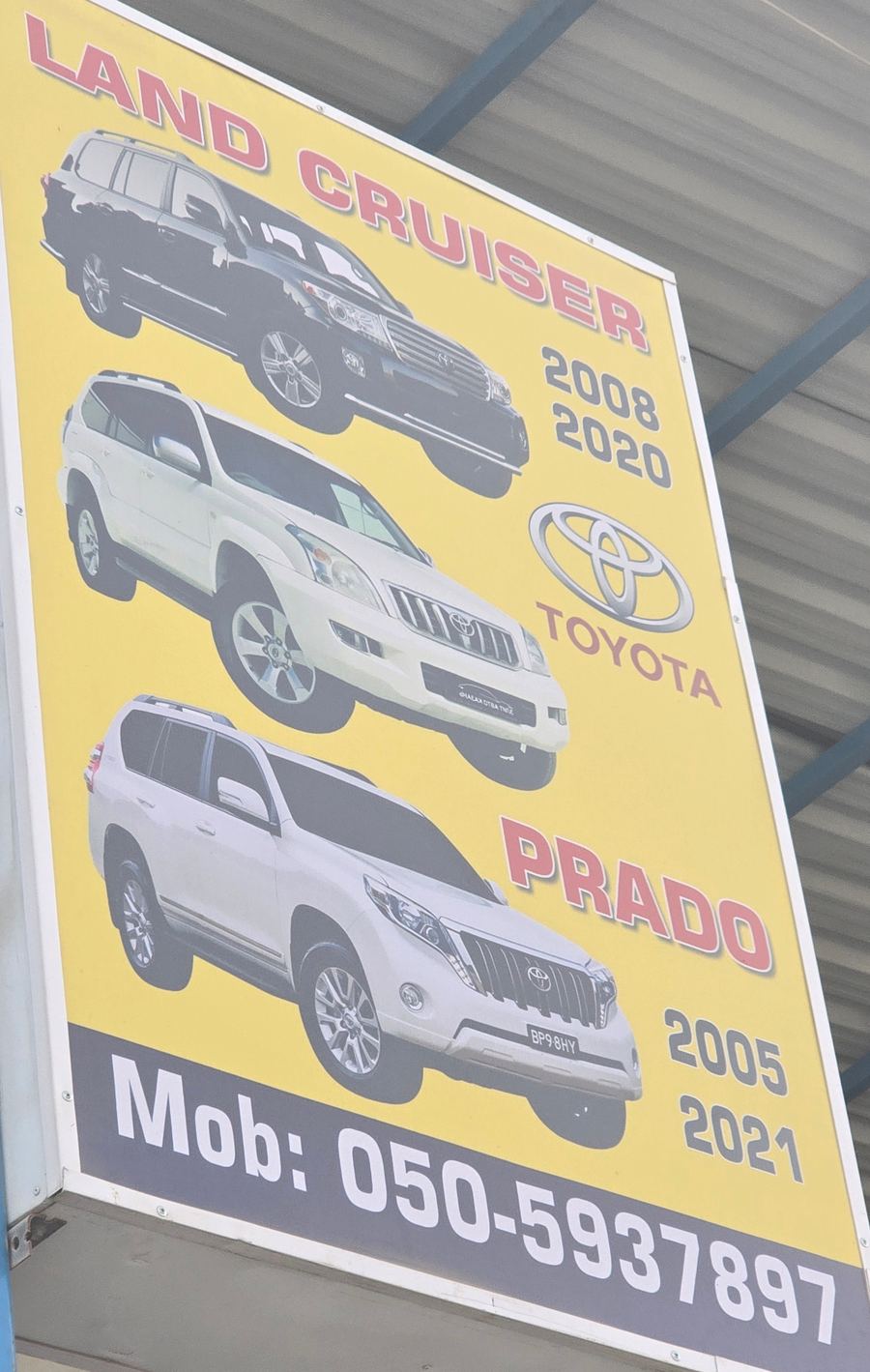Banner photographed at Toyota stall of RAHMAN WALI USED CARS & SPARE PARTS